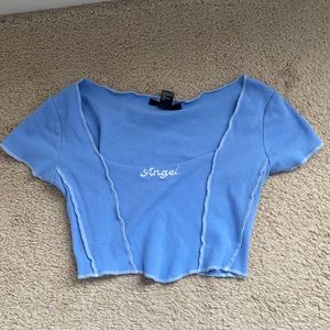 Baby blue crop top with “Angel” written across it. Forever 21, size small.